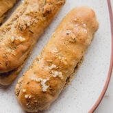 Plate of gluten-free Italian breadsticks.