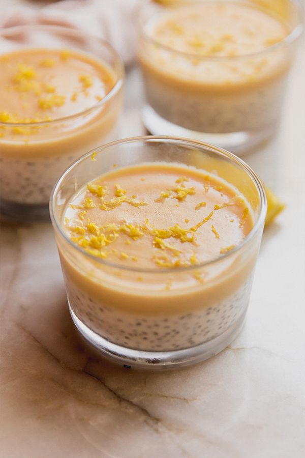 Several cups of creamy lemon chia pudding on a counter.