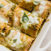 Baking dish of white pesto lasagna roll ups.