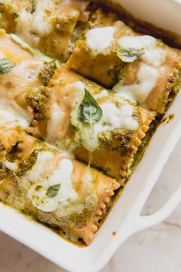 A casserole dish filled with white pesto lasagna roll-ups