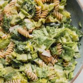 Chicken Caesar pasta salad in a large blue bowl
