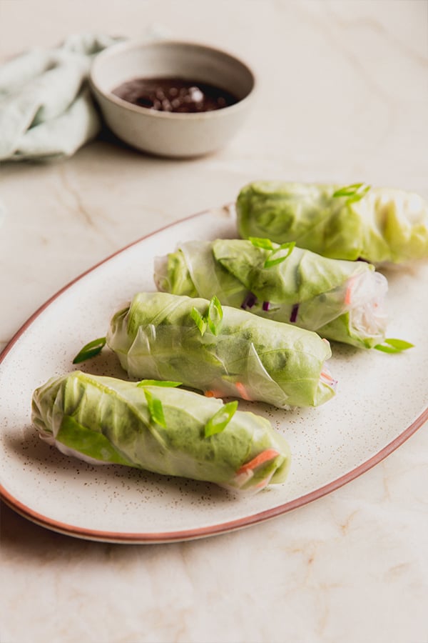 A platter of chicken and vegetable spring rolls ready on a serving platter.