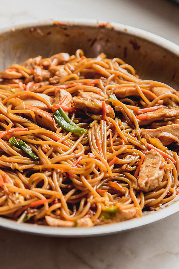 A pan of chicken chow mein after cooking.