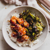 Sesame chicken and broccoli in a bowl with rice.