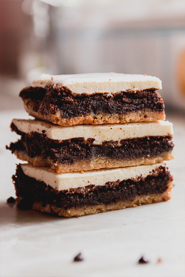 A stack of s'mores brownies stacked on top of each other on a counter.