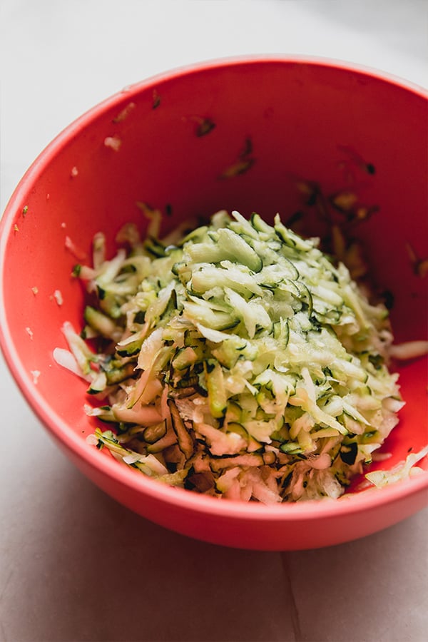 A mixing bowl of shredded zucchini.