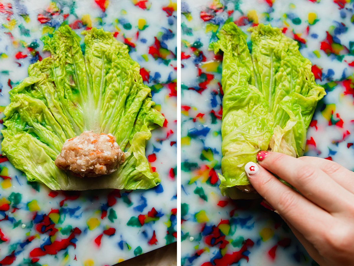 Placing the middle mixture into the cabbage and then rolling the cabbage.