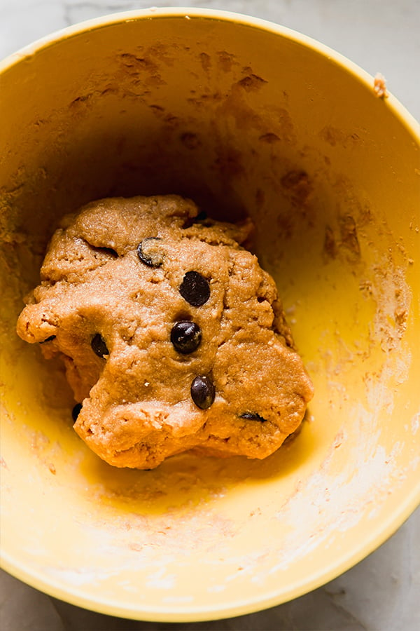 The dough to make cookie dough protein bars in a bowl.
