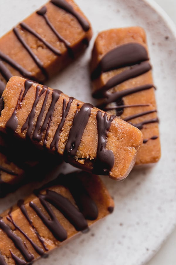 A plate stacked with cookie dough protein bars.