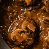 Hamburger steak topped with mushrooms and gravy.