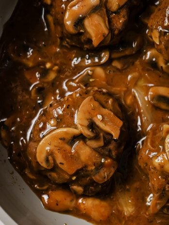Hamburger steak topped with mushrooms and gravy.