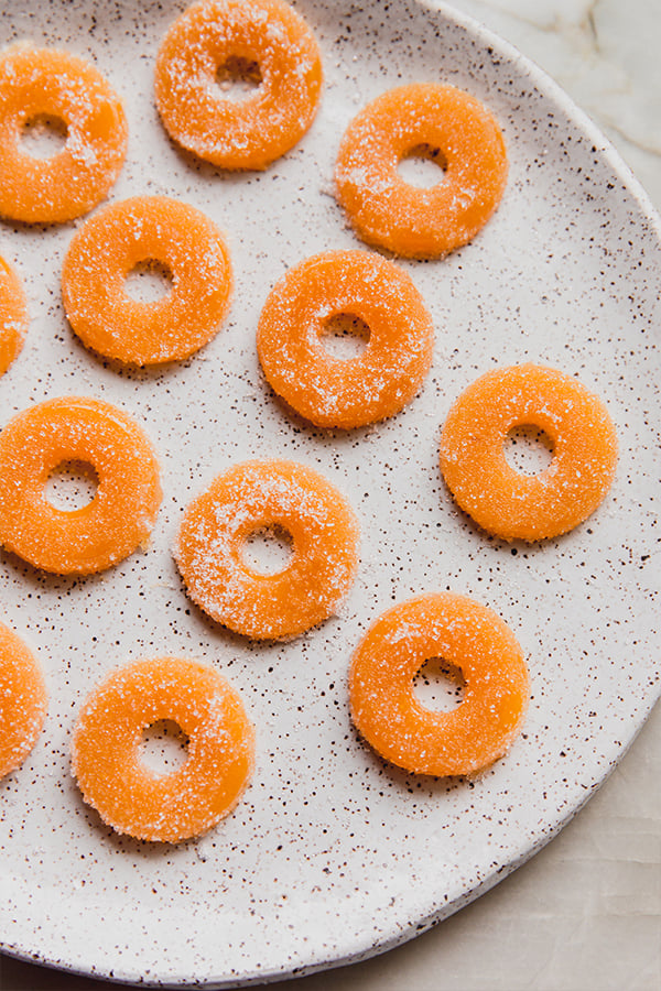 A plate filled with peach ring gummies.