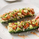 Cucumber boat sliced in half stuffed with salmon, avocado, rice and topped with spicy mayo.