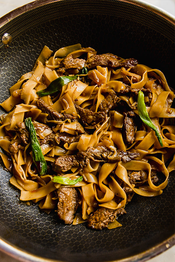 A serving bowl of beef chow fun before eating.