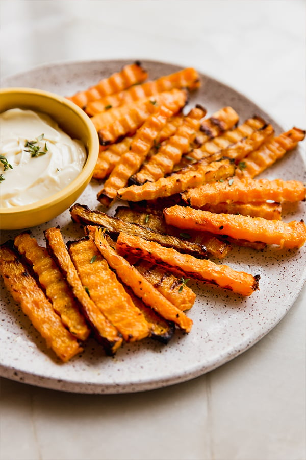 A platter with butternut zig-zag fries with dipping sauce.