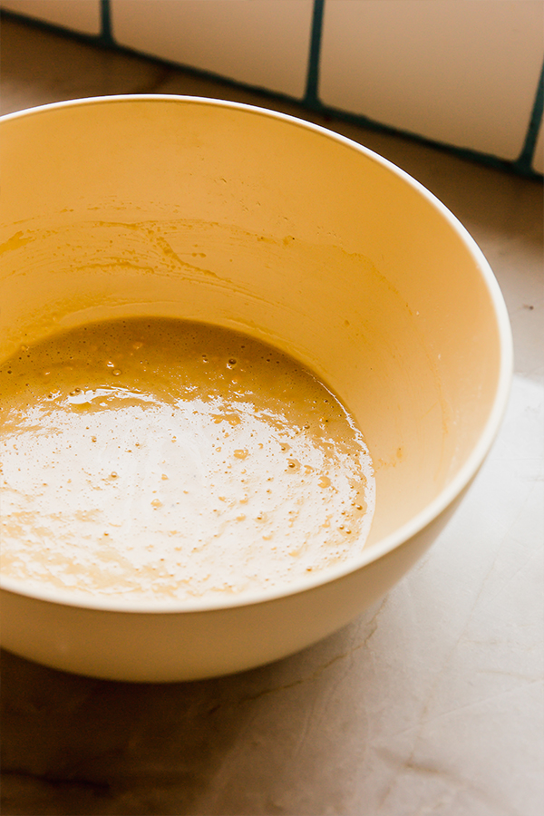 The batter for chickpea flatbread in a mixing bowl.