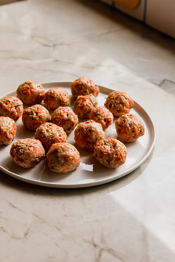 A plate filled with hidden veggie meatballs before cooking.