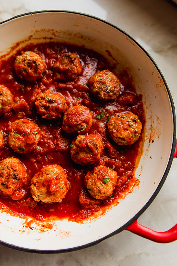 A pot filled with hidden veggie meatballs after cooking.