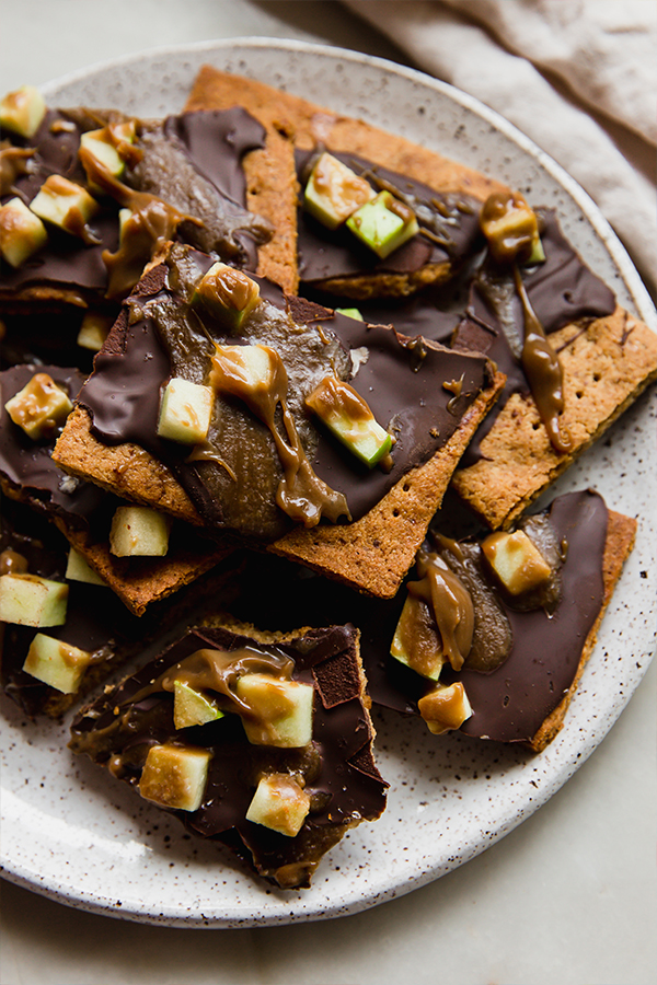 A platter stacked with caramel apple graham cracker bark.