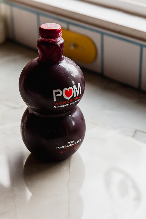 A bottle of pomegranate juice on a counter, which is a key ingredient in pomegranate jello.