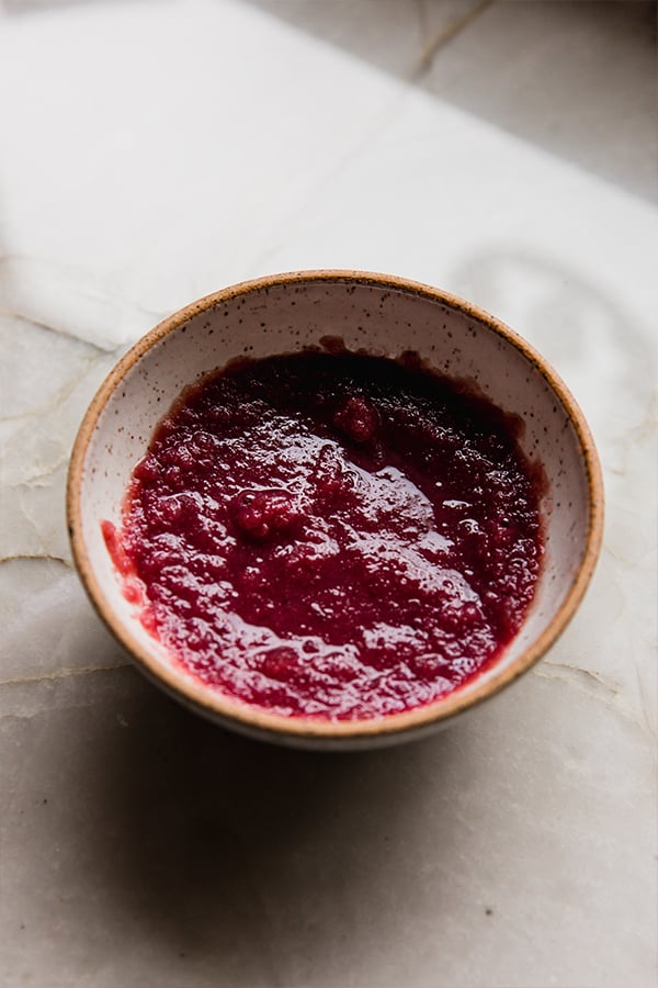 A bowl of pomegranate juice mixing with gelatin.