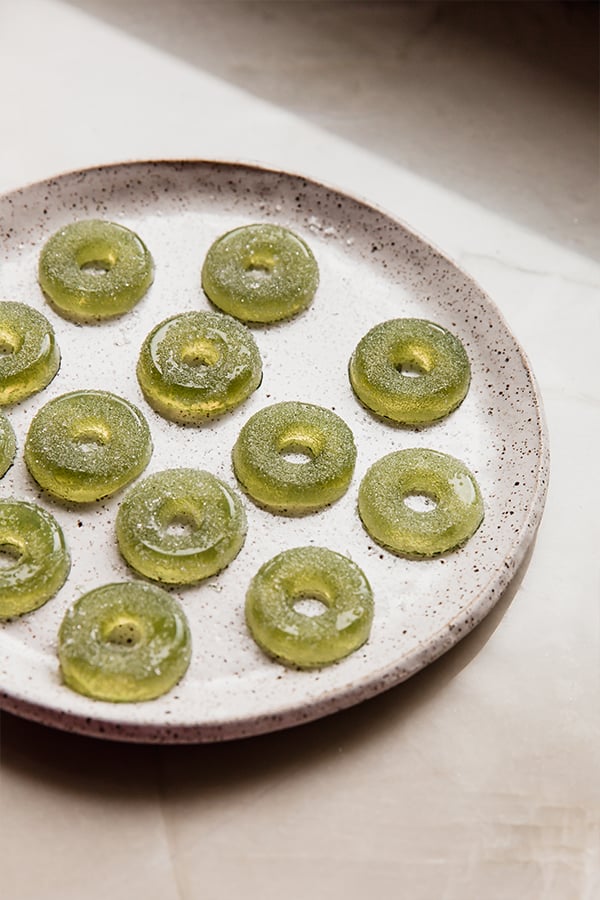 A plate full of apple ring gummies.