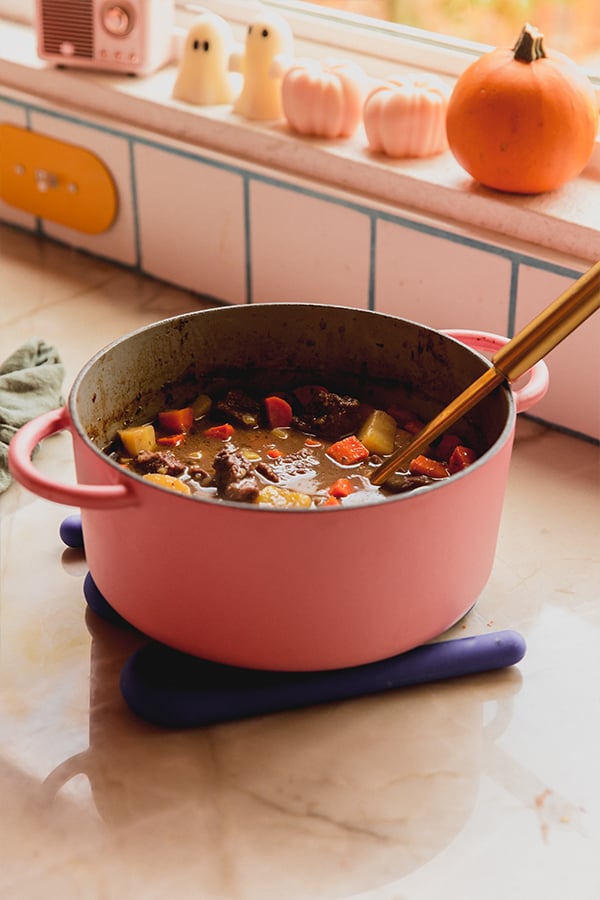 A pot of dutch oven beef stew on a counter after being cooked.
