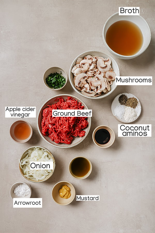 Ingredients for hamburger steak layed out in seperated dishes. 