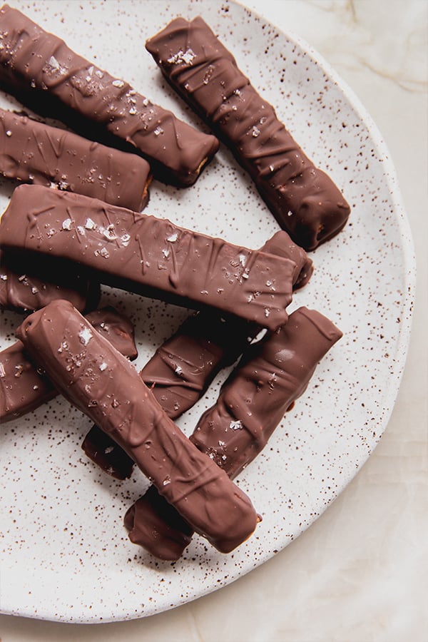 A plate stacked with kit-kat bars on it.