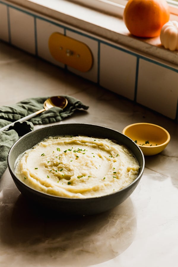 A bowl of instant pot mashed potatoes sitting on the counter.