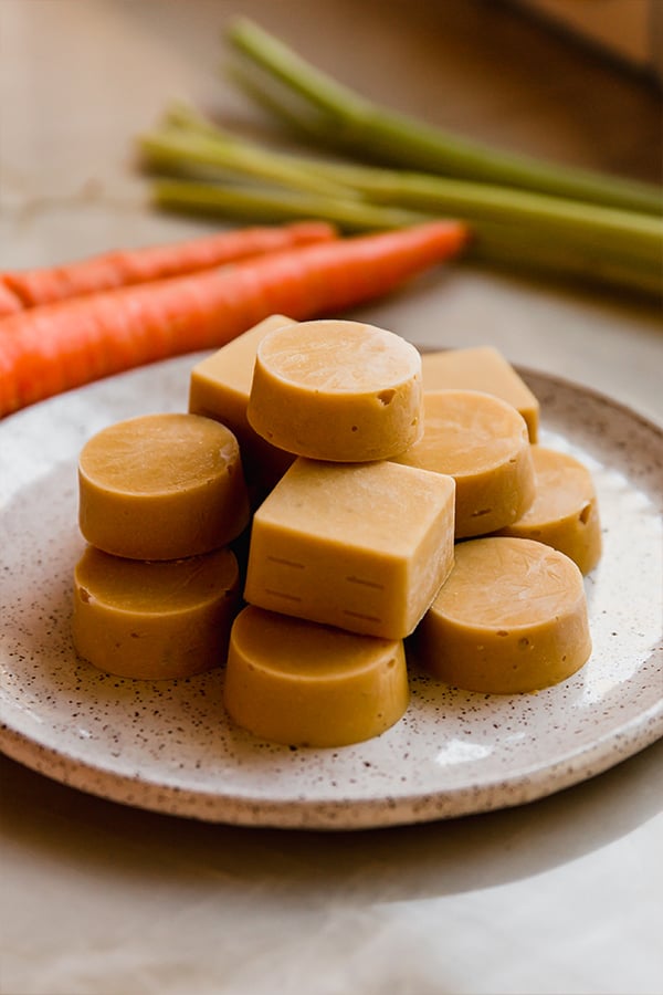 A plate stacked with homemade chicken bouillon cubes,