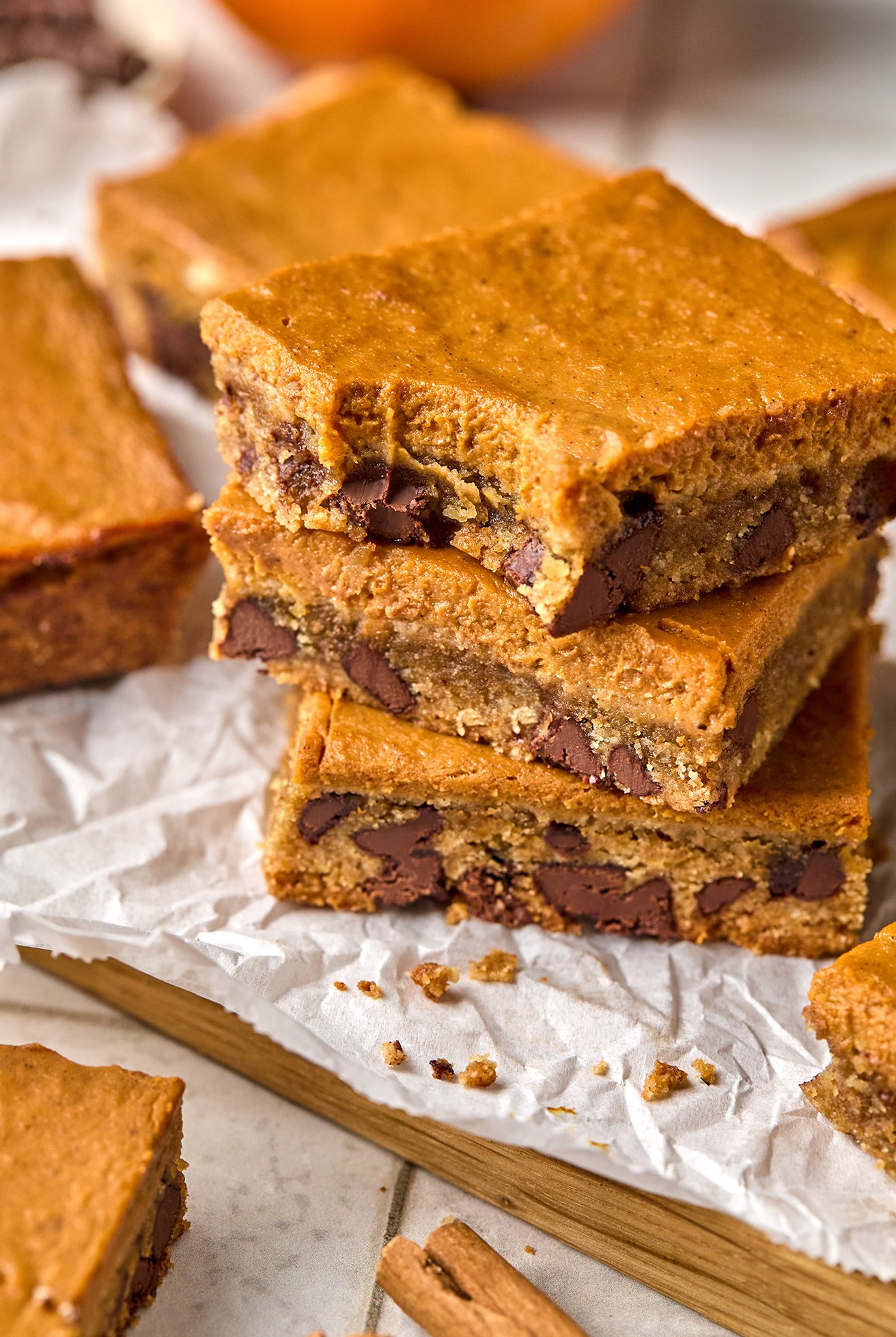 Three pumpkin chocolate cookies bars stacked on top of each other. 