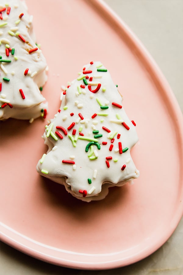 A plate filled with two copycat Little Debbie Christmas tree cakes.