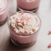 Peppermint pie cheesecake cup topped with crushed candy.