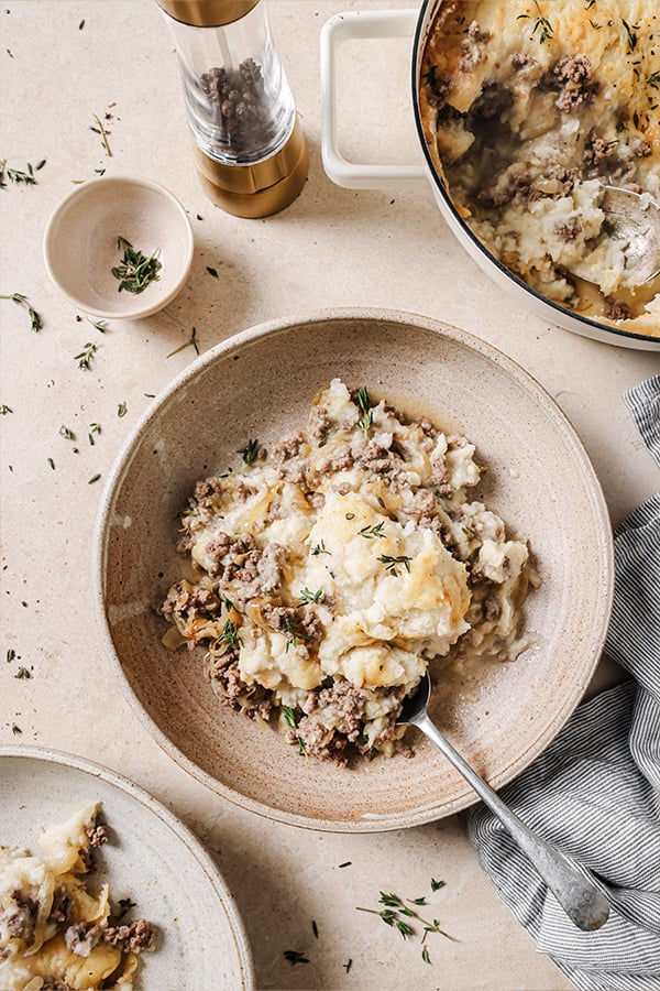 A serving of French onion shepherd's pie in a bowl ready to be enjoyed.