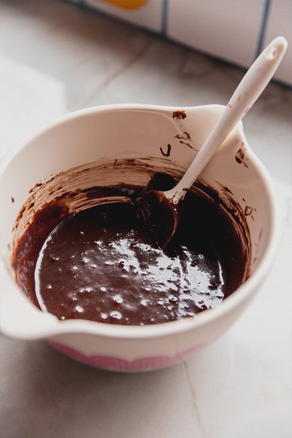 A mixing bowl filled with batter for chocolate lava cakes.