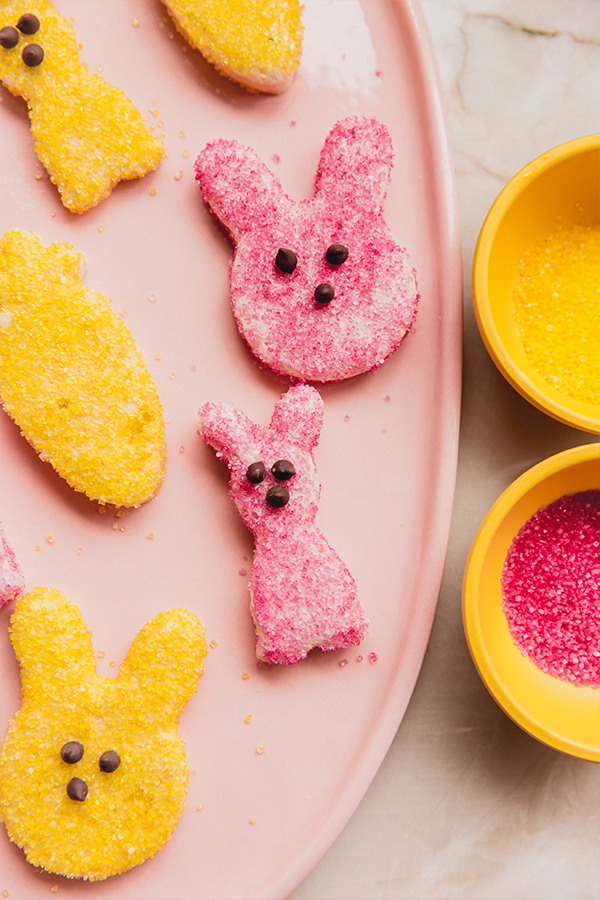 A serving plate topped in homemade peeps in yellow and pink sugar.