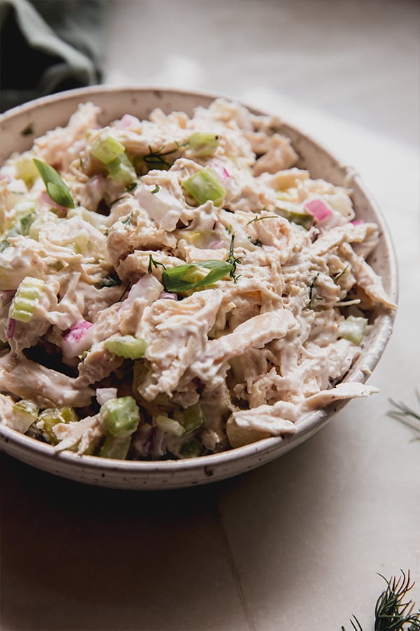 A bowl of easy dill pickle chicken salad before being added to a sandwich, crackers, or anything else.