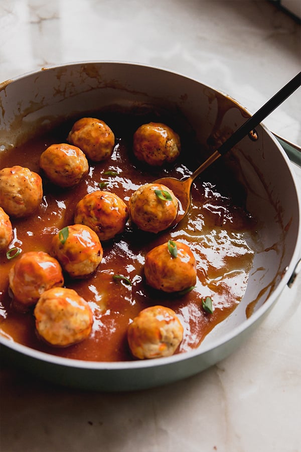A pan with the sweet & sour chicken meatballs after cooking.