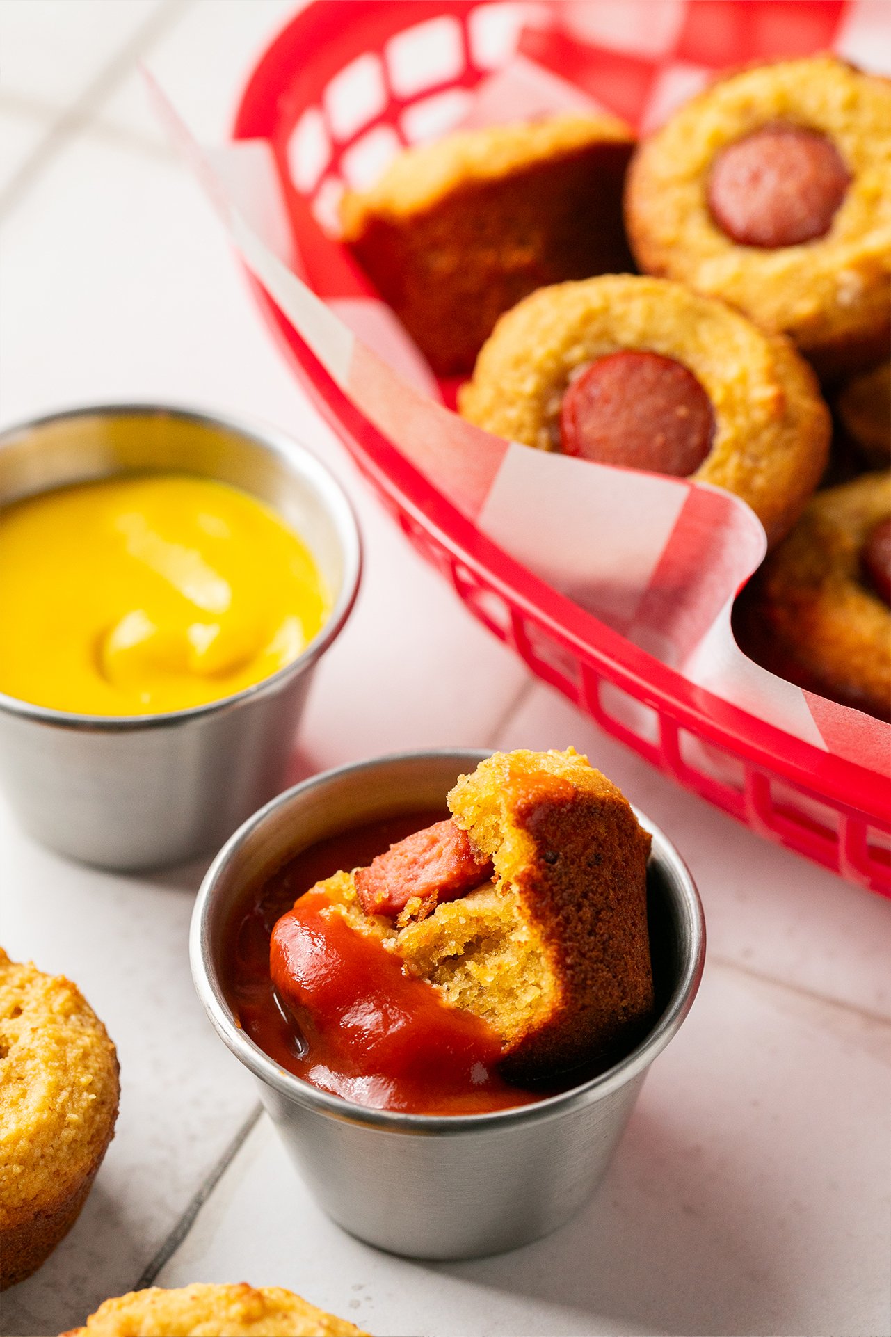 Corn dog muffin being dipped in ketchup.
