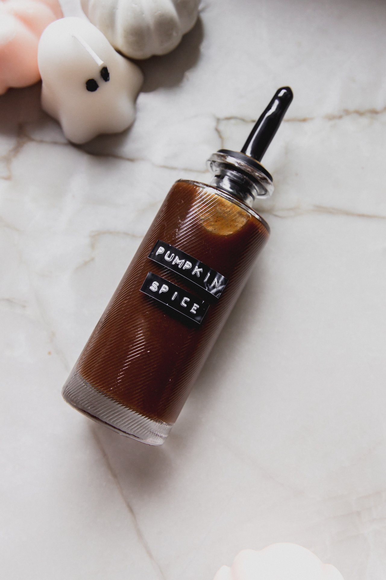 Pumpkin spice syrup in a bottle with a label.