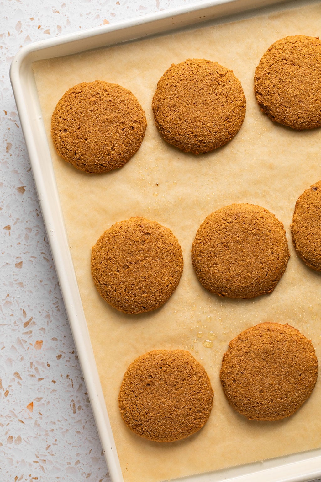 Gluten free pumpkin cookies baked on a baking sheet.