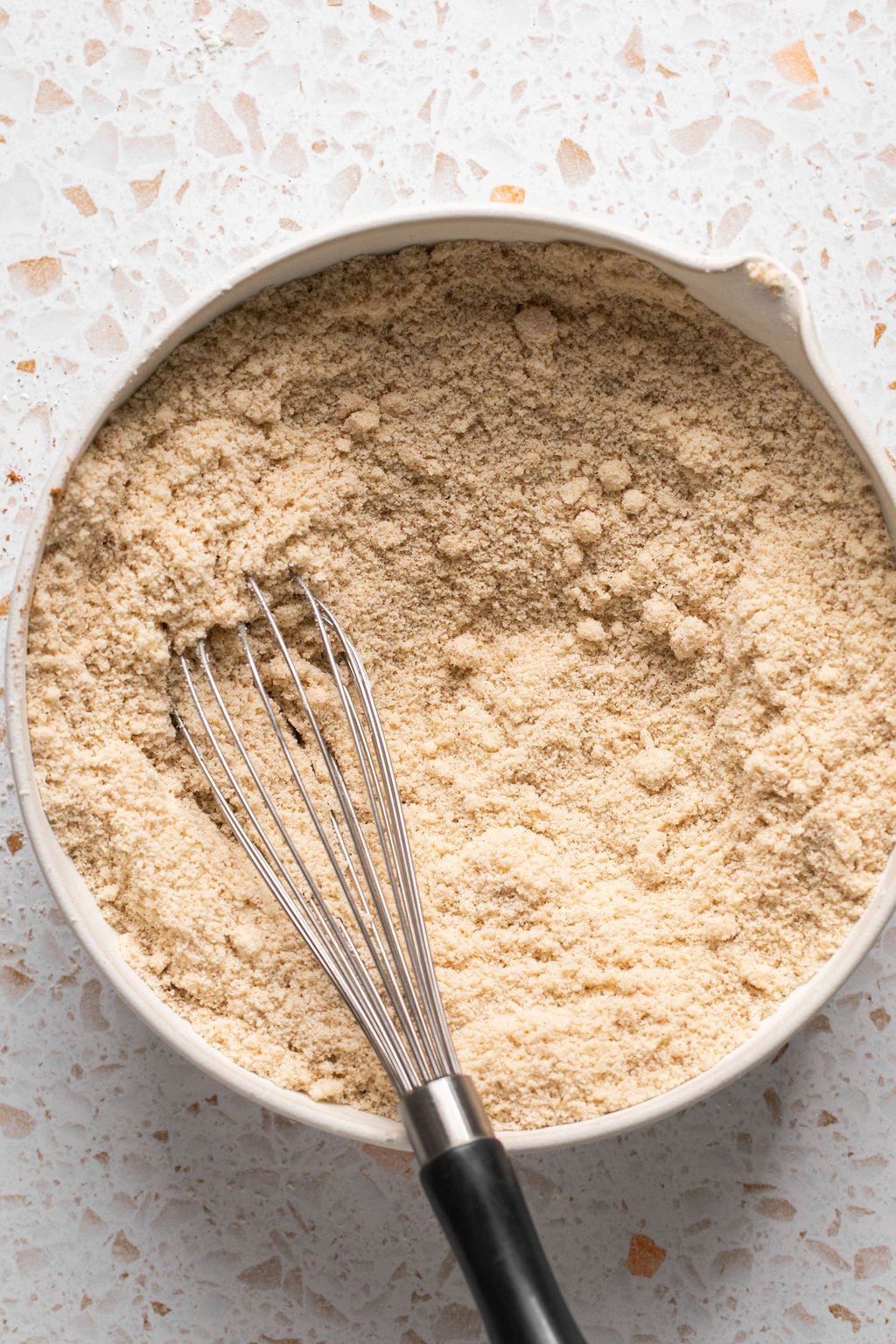 Pumpkin spice cookie dry ingredients in a bowl with a whisk.