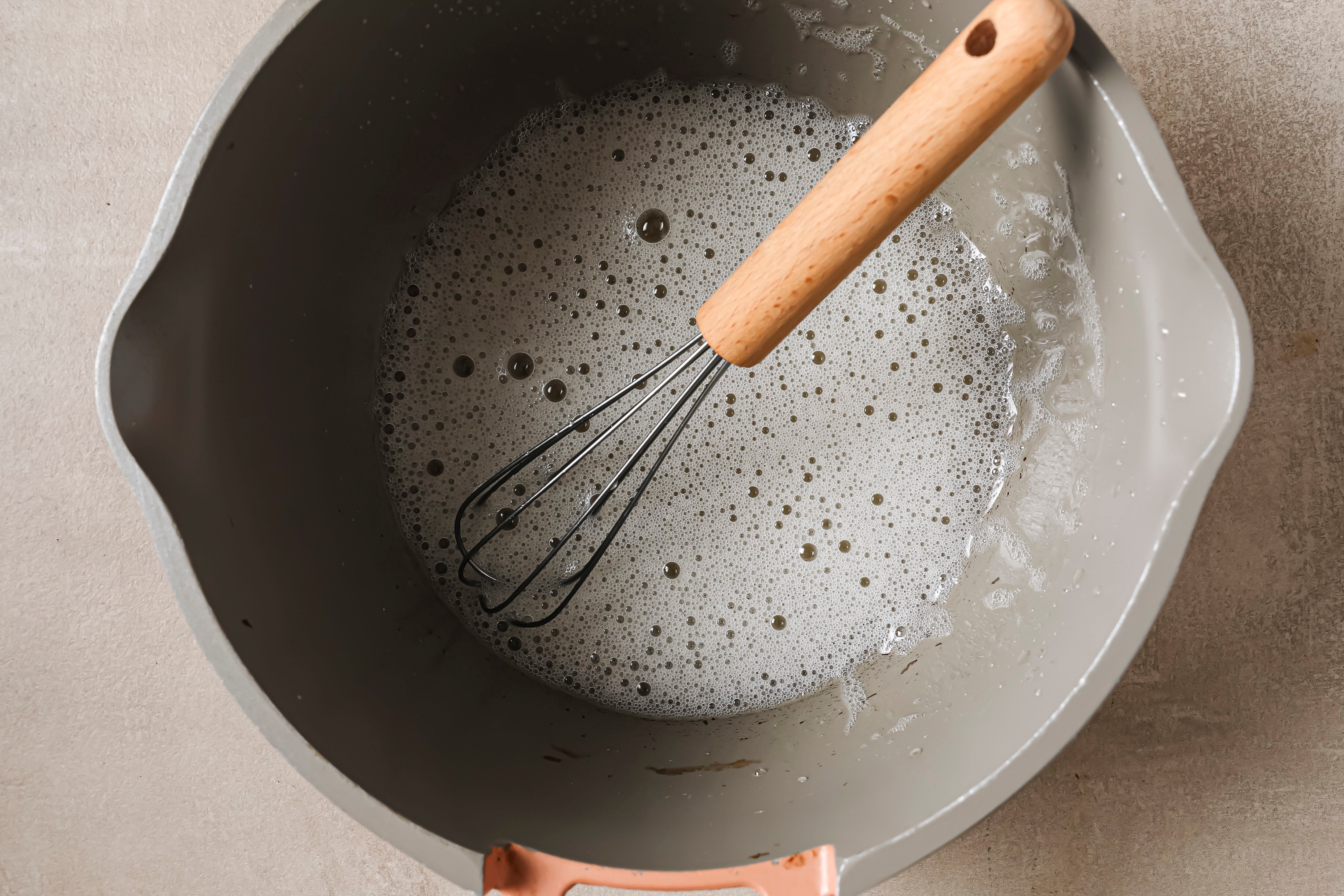 Gelatin egg in a pot after the mixture has been heated and frothed.