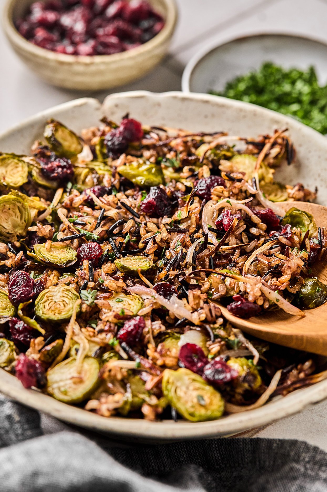 Crispy wild rice pilaf in a bowl with a wooden spoon.