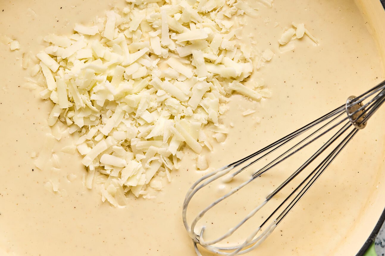 Shredded cheese being added to the bowl.