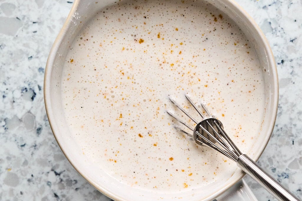 A bowl with coconut milk and arrowroot starch mixed together.