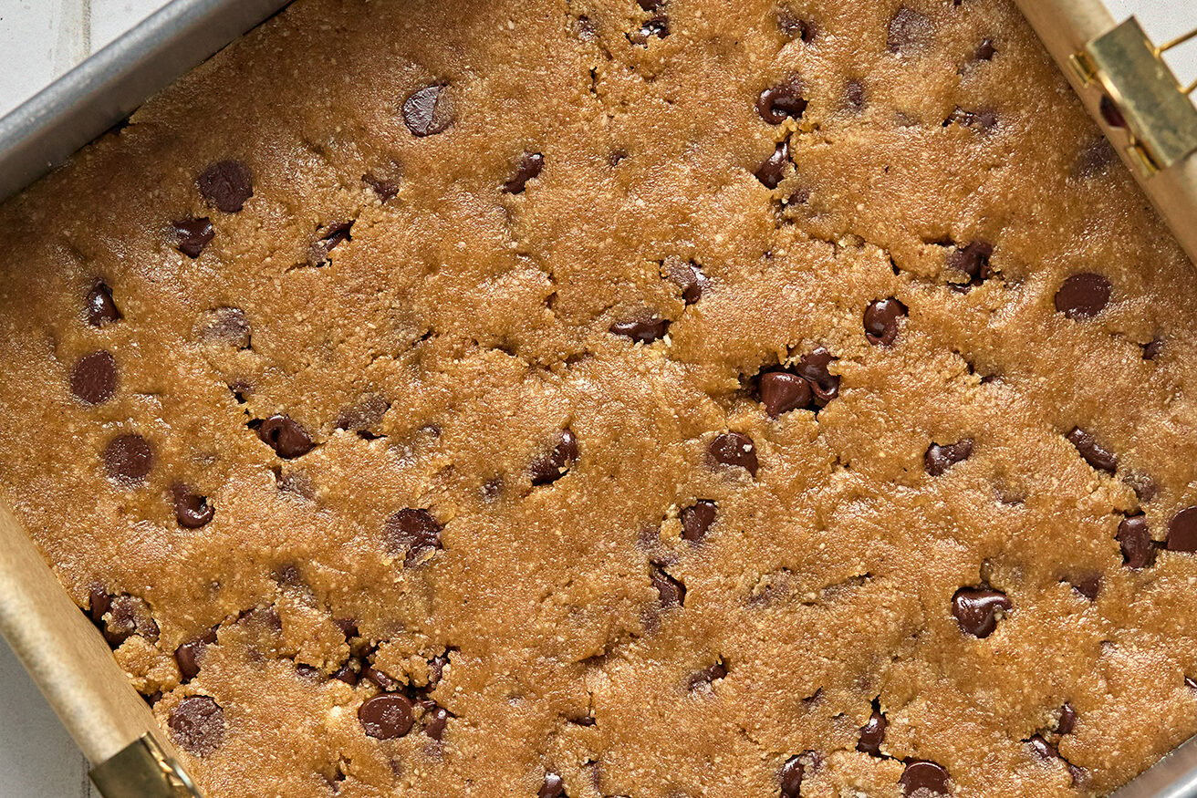 Cookie bar dough pressed into a baking pan. 