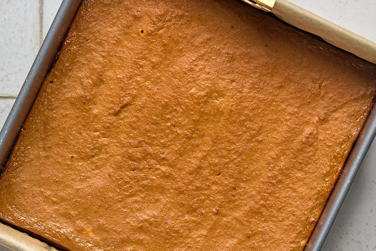 Pumpkin cookie bars baked in an 8x8" pan. 