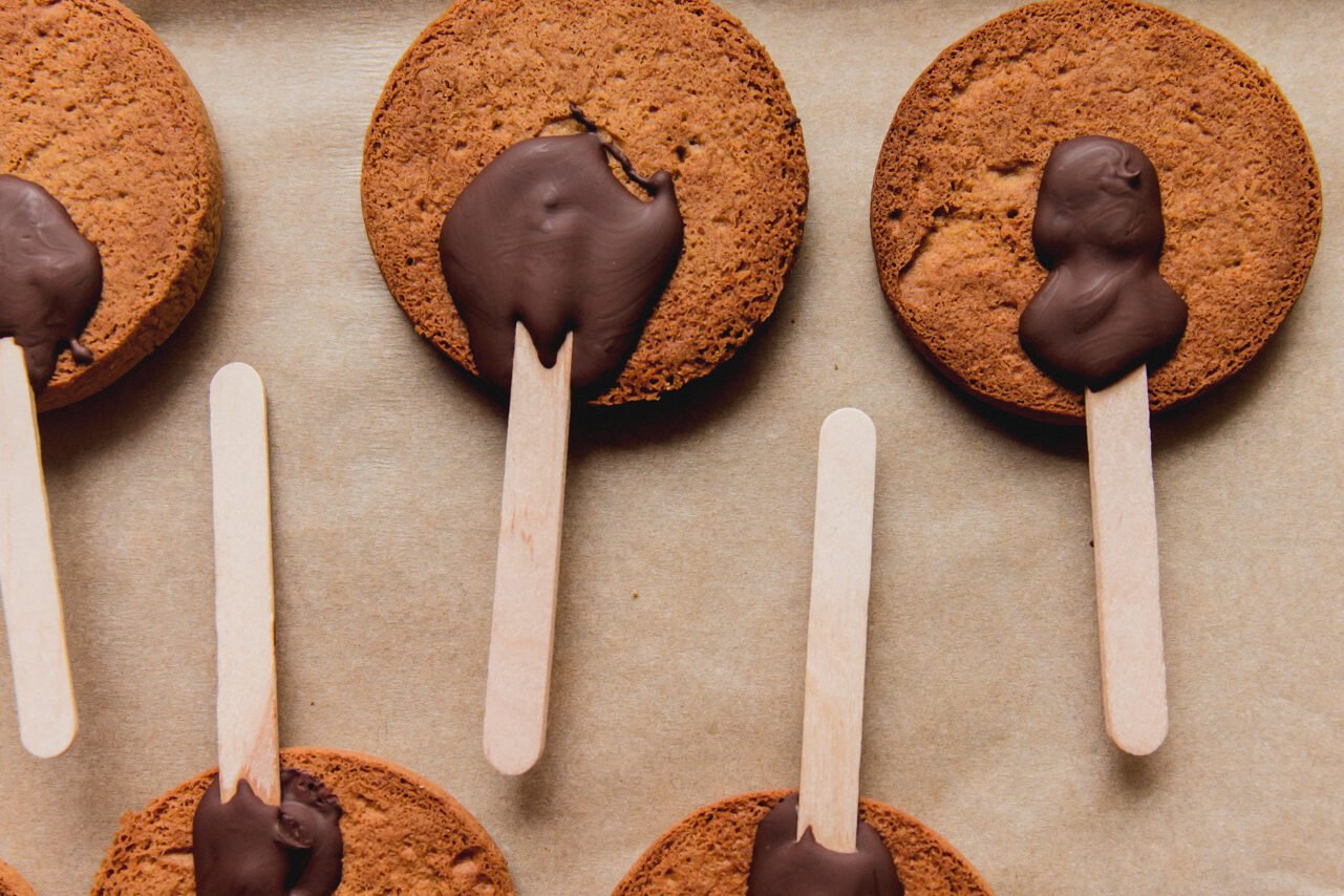 Gingerbread cookies with chocolate and popsicle sticks attached to it